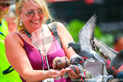 Image of Woman holding pigeons