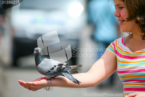 Image of Girl holding pigeon