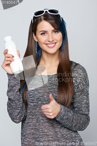 Image of Healthy woman showing a bottle of dairy produce