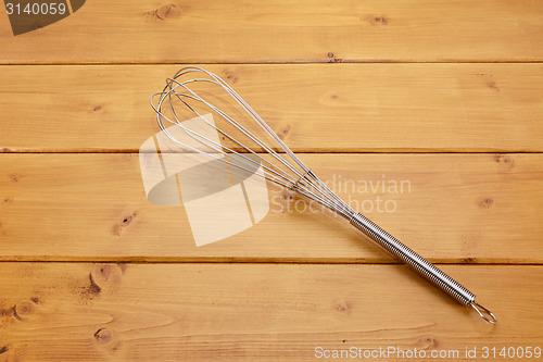 Image of Metal whisk on a table