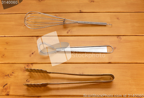 Image of Balloon and sauce whisks and metal tongs