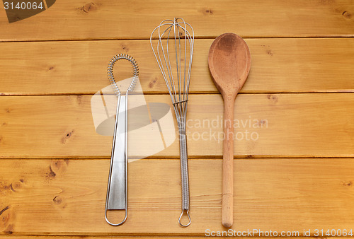 Image of Sauce and balloon whisks and wooden spoon 