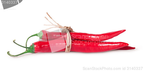 Image of Red chili peppers tied with a rope