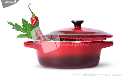 Image of Parsley with red chili pepper in saucepan