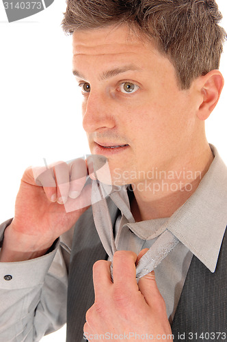 Image of Man taking of tie.