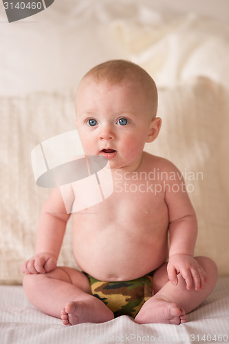 Image of Young Blue Eyed Infant Boy Sitting Up Camo Underwear