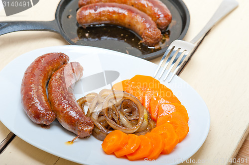Image of beef sausages cooked on iron skillet 