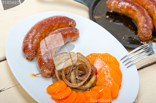 Image of beef sausages cooked on iron skillet 