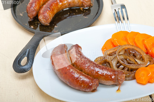 Image of beef sausages cooked on iron skillet 