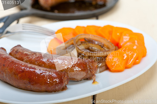 Image of beef sausages cooked on iron skillet 