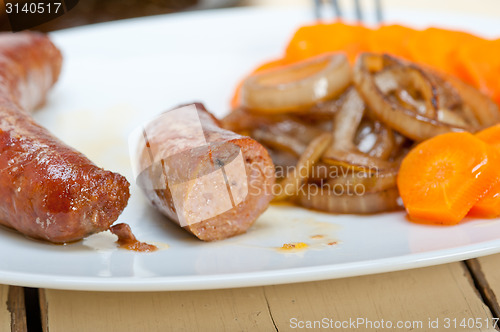 Image of beef sausages cooked on iron skillet 