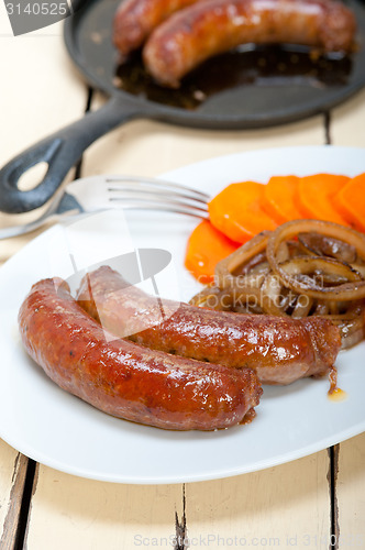 Image of beef sausages cooked on iron skillet 