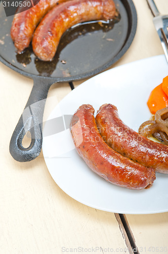 Image of beef sausages cooked on iron skillet 