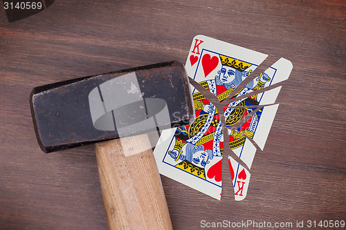 Image of Hammer with a broken card, king of hearts