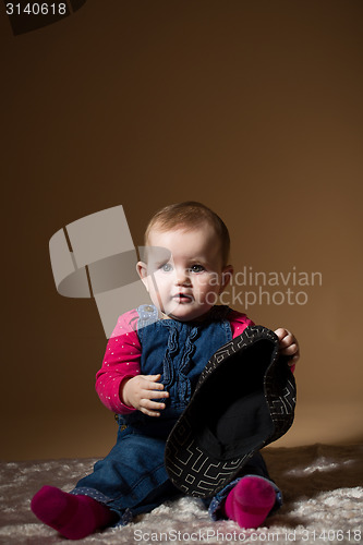 Image of infant baby with black hat