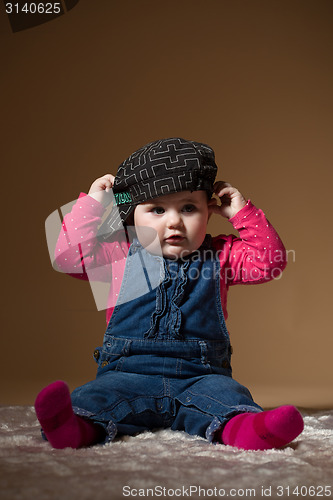 Image of infant baby with black hat