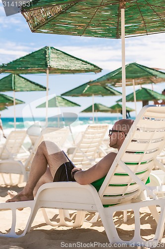 Image of young man on the beach