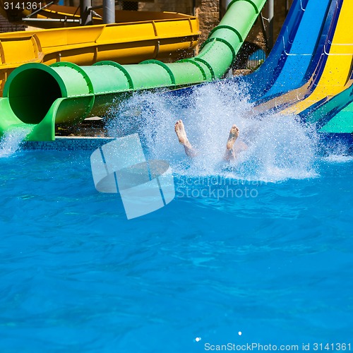 Image of Happy woman sliding water park.