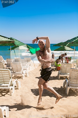 Image of young man on the beach