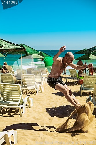 Image of young man on the beach