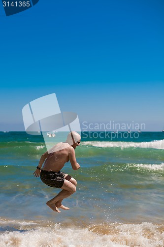 Image of young man on the beach