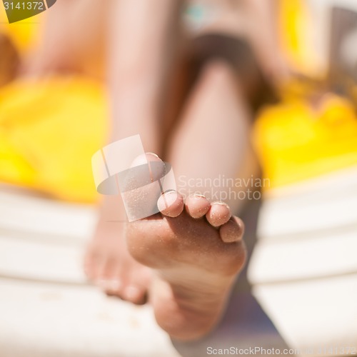 Image of Young woman feet at the beach