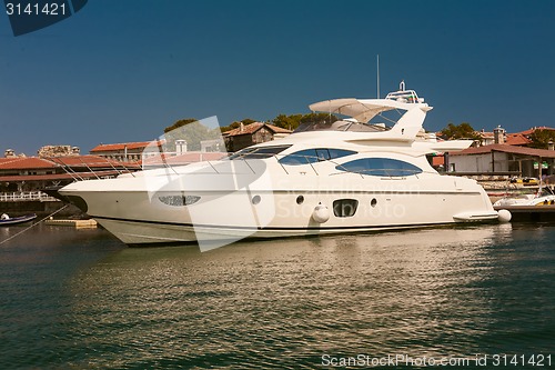 Image of Row of luxury motorised yachts moored in a sheltered harbour