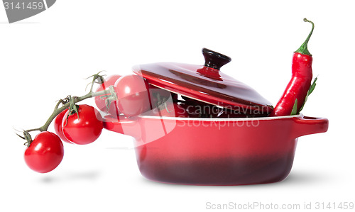 Image of Cherry tomatoes with parsley and chili in saucepan