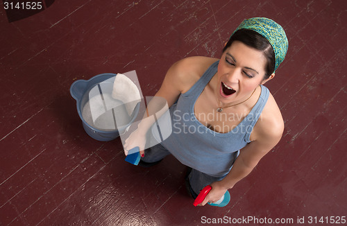 Image of Tired Blue Collar Worker Maid Doing Cleaning Chores Scrubbing Fl