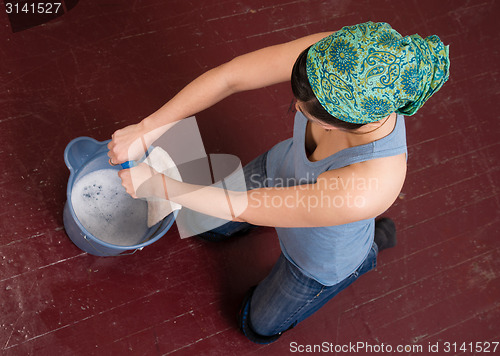 Image of Blue Collar Worker Maid Doing Cleaning Chores Scrubbing Floor