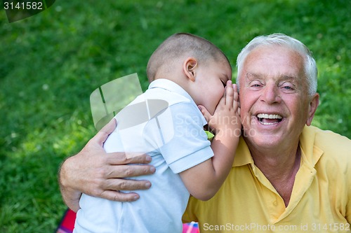 Image of grandfather and child have fun  in park