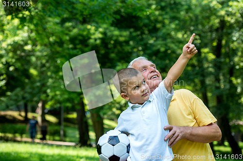 Image of grandfather and child have fun  in park