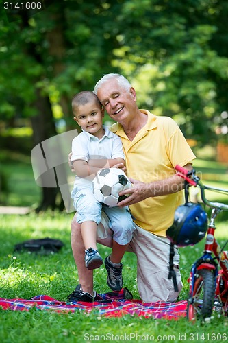 Image of grandfather and child have fun  in park