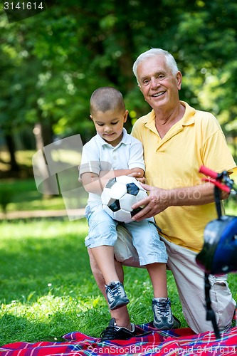 Image of grandfather and child have fun  in park