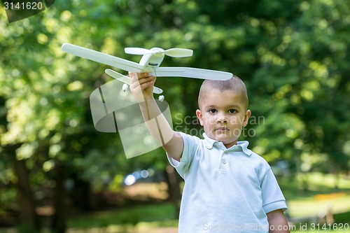 Image of boy with airpane toy