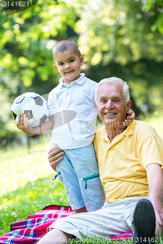 Image of grandfather and child have fun  in park