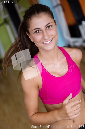 Image of woman exercising on treadmill in gym