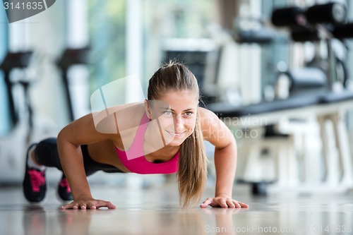 Image of warming up and doing some push ups a the gym