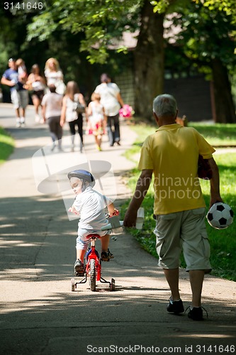 Image of grandfather and child have fun  in park