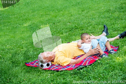 Image of grandfather and child using laptop