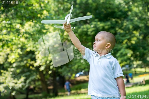 Image of boy with airpane toy