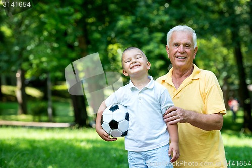 Image of grandfather and child have fun  in park