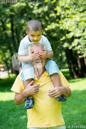 Image of grandfather and child have fun  in park