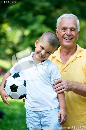 Image of grandfather and child have fun  in park