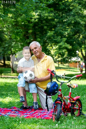 Image of grandfather and child have fun  in park