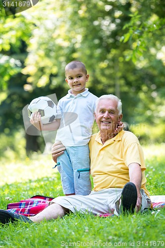 Image of grandfather and child have fun  in park