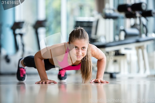 Image of warming up and doing some push ups a the gym