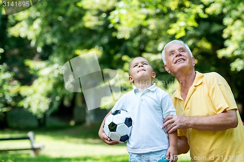 Image of grandfather and child have fun  in park