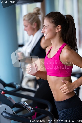 Image of lifting some weights and working on her biceps in a gym