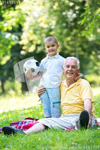 Image of grandfather and child have fun  in park